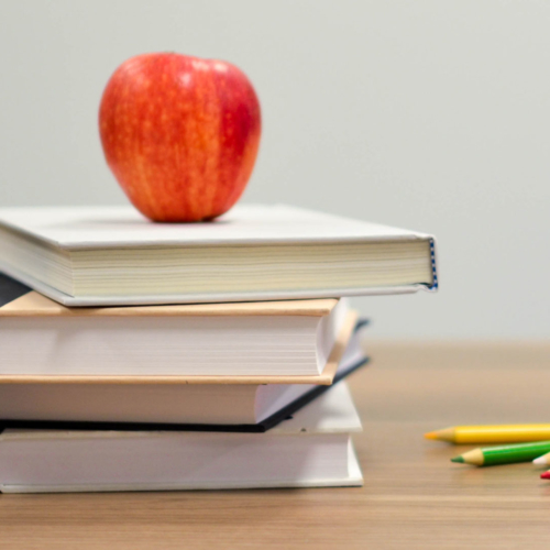 Apple books and pencils on a desk