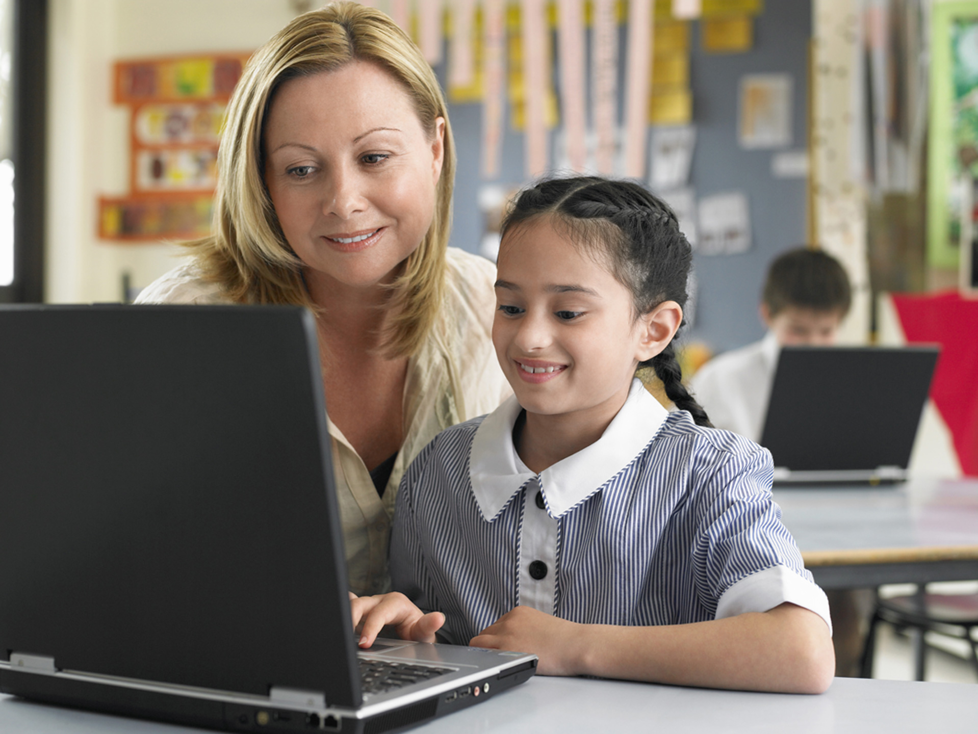 Young-School-Girl-on-Laptop-with-Teacher1440