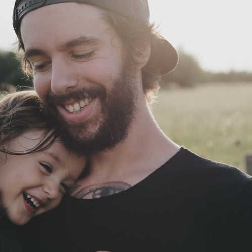 Smiling girl hugs man