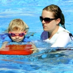 child-swimming-with-teacher2160