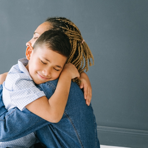 Tween boy hugging mum