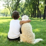 young-teen-hugging-dog-in-park2160