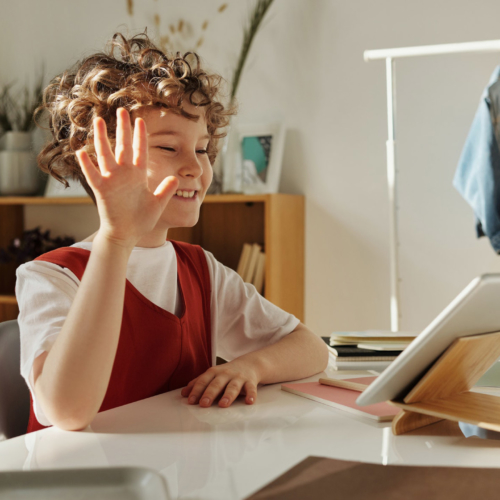 child-smiling-waving-while-using-tablet2160