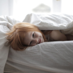 girl-lying-in-bed-white-linen2160