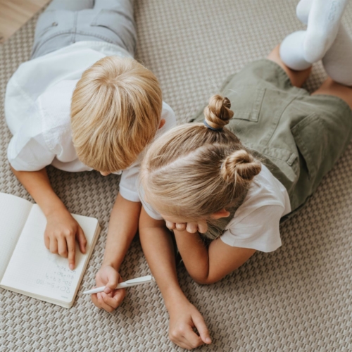 siblings-lying-down-writing2160