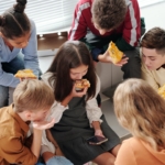 teens-eating-pizza-with-one-on-phone2160