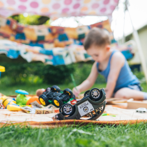 boy-on-mat-plying-outside2160
