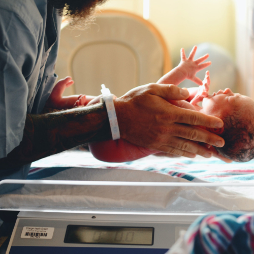 newborn-held-in-delivery-room