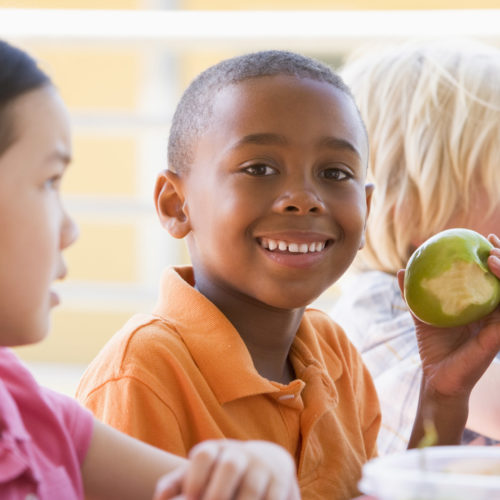 multicultural kids eating school lunch