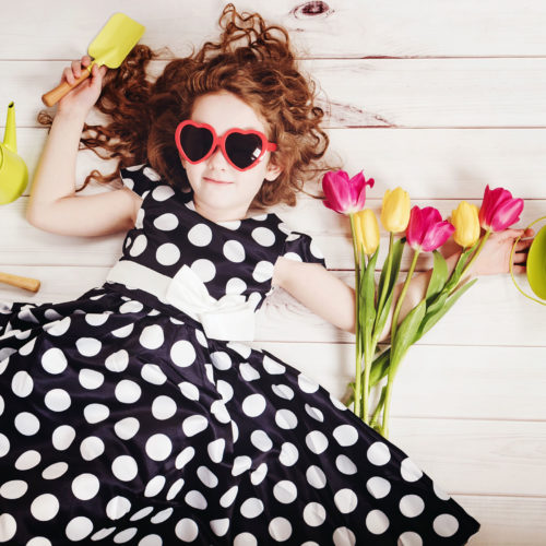 girl in black and white spotted dress